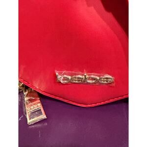 NWT vibrant red, heart-shaped crossbody bag by the brand Bebe, the Milan Heart